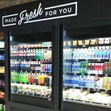 Grocery refrigerated case with bottled beverages